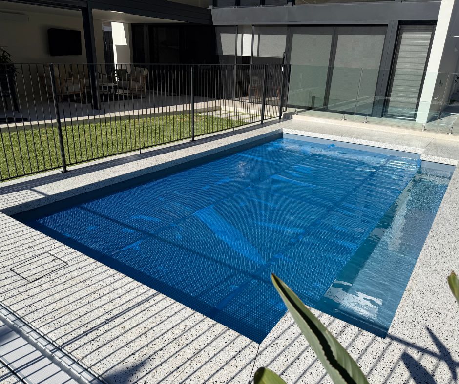 Complete pool solution with Below Ground Box in foreground and Daisy pool cover on pool