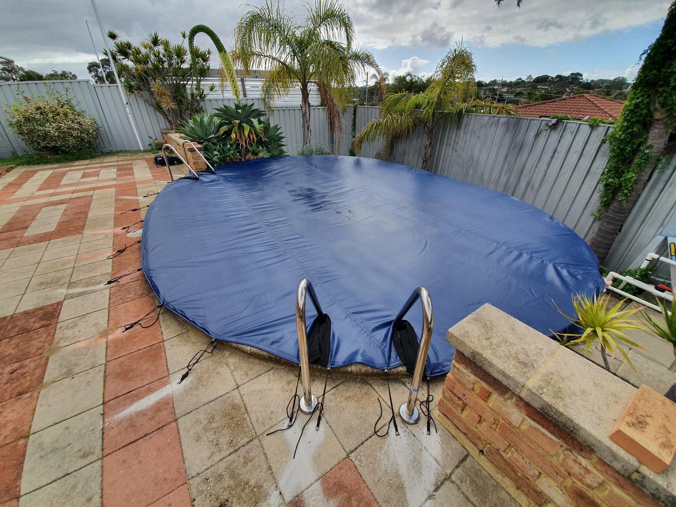   A WinterKleen Blue Debris Cover with the ladder steps cut out and cover goes over the wall.