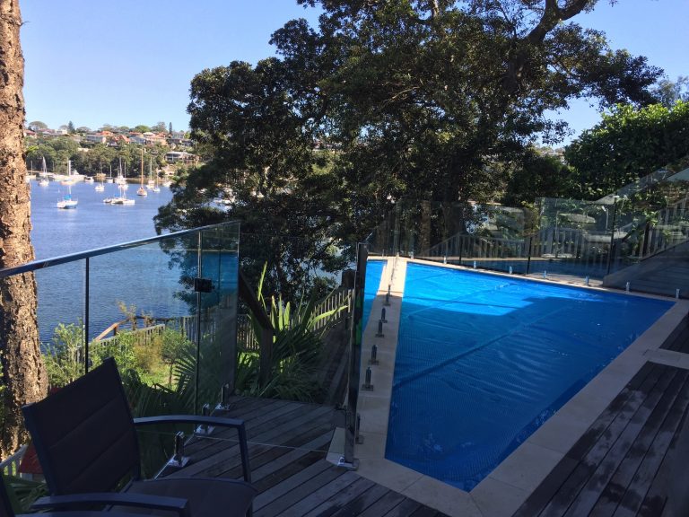 A triangular shaped pool, up high with a stunning view.