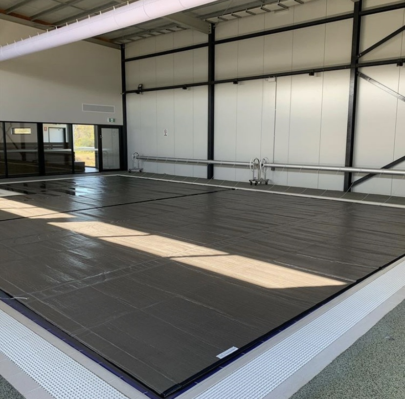  An indoor pool with a ThermoTech Silver cover. 